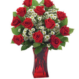 Red roses and white daisy-like flowers in a red glass vase