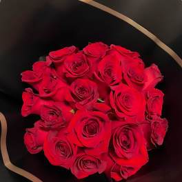 Bouquet of red roses wrapped in black paper