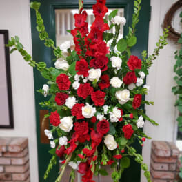 Tall red and white floral standing spray with roses and carnations