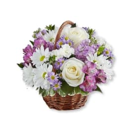 Basket of white roses, daisies, and purple flowers