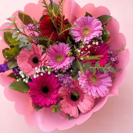 Bouquet of pink and magenta gerbera daisies with pink wrap