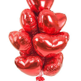 Cluster of red heart-shaped balloons tied together with a ribbon