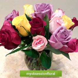Bouquet of multicolored roses in a glass vase