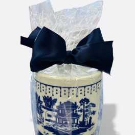 Wrapped decorative candle with a navy bow