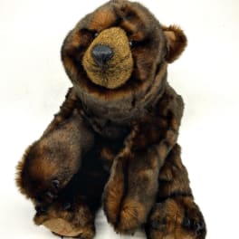 Brown plush teddy bear sitting on a white background