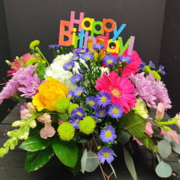 Colorful birthday bouquet with mixed flowers and a "Happy Birthday" sign