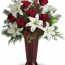 Red roses and white lilies in a tall red vase