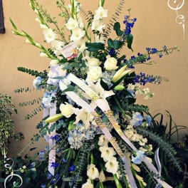 Tall white floral spray with blue accents and ribbon streamers