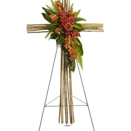 Floral cross on a stand with roses and orange blooms