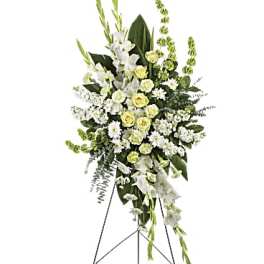 Standing floral spray of white and pale yellow flowers on an easel