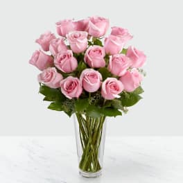 Pink roses arranged in a clear glass vase