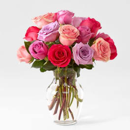 Mixed pink and lavender roses in a clear glass vase