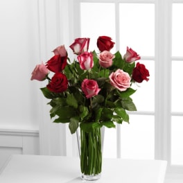 Bouquet of red and pink roses in a clear glass vase