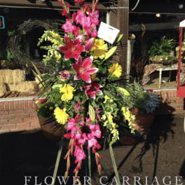 Tall standing floral spray with pink lilies and yellow daisies