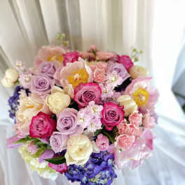 Bouquet of pink, lavender, and cream flowers with roses and hydrangeas