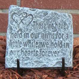 Decorative stone plaque with a heart design and engraved memorial quote