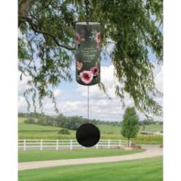 Hanging cylindrical wind chime with floral decoration outdoors