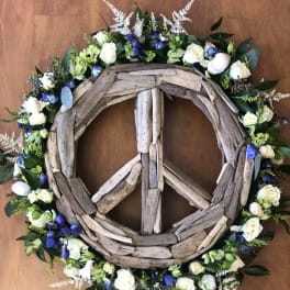 Driftwood peace sign wreath with white and blue flowers