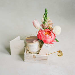 Gift basket with flowers, a candle, and a thank-you card