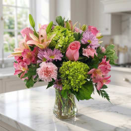 Pink and lavender mixed bouquet in a clear glass vase
