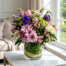 Mixed pink and purple bouquet in a clear glass vase