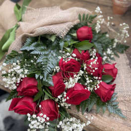 Bouquet of red roses with baby's breath wrapped in burlap