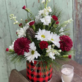 Red and white flower arrangement in a plaid tin container