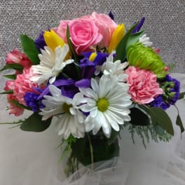 Bouquet of pink roses, white daisies, and colorful mixed flowers