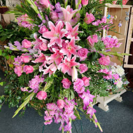 Large pink floral standing spray with lilies and roses