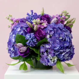 Purple and blue hydrangea bouquet in a glass vase