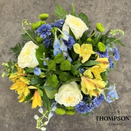 Bouquet of white roses, yellow alstroemeria, and blue flowers