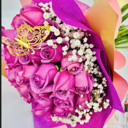 Bouquet of pink roses with white baby's breath wrapped in bright purple paper