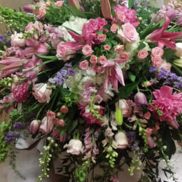 Large pink and white floral arrangement with lilies, roses, and mixed blooms