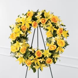 Yellow floral wreath on a black easel stand