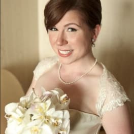 Bride holding a white orchid bouquet