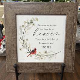 Framed memorial sign with a red cardinal and floral illustration