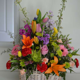 Mixed flower basket with lilies, roses, gerberas, and carnations