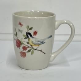 Cream ceramic mug with a bird and floral branch design