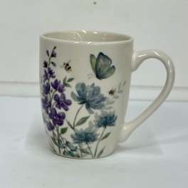 White ceramic mug with purple and blue floral and butterfly print