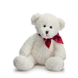 White teddy bear with a red ribbon bow