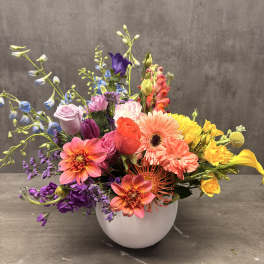 Colorful mixed bouquet in a white round vase