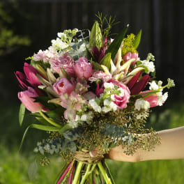 Hand-tied bouquet of pink and white flowers with long stems