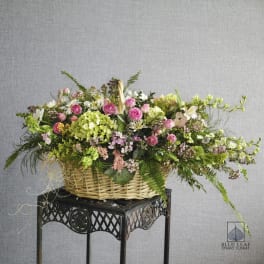 Large basket arrangement with pink roses and mixed blooms