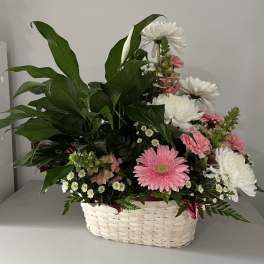 Basket arrangement with pink and white daisies and mixed blooms