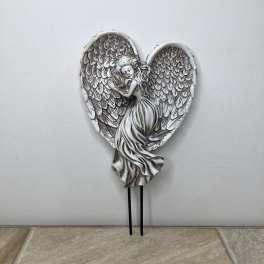 Silver angel figurine with large wings on a heart-shaped plaque