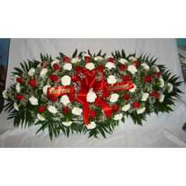 Sympathy floral spray with red roses and white carnations