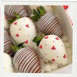 Box of chocolate-covered strawberries with heart decorations
