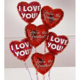 Cluster of red heart-shaped balloons with love messages