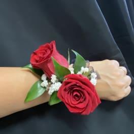 Red rose wrist corsage with white filler flowers