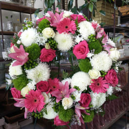 Large pink and white floral wreath on an easel